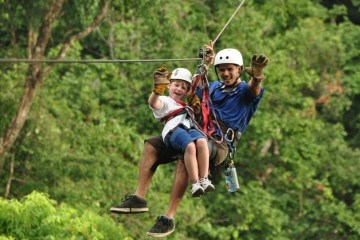 adult and child on zipline